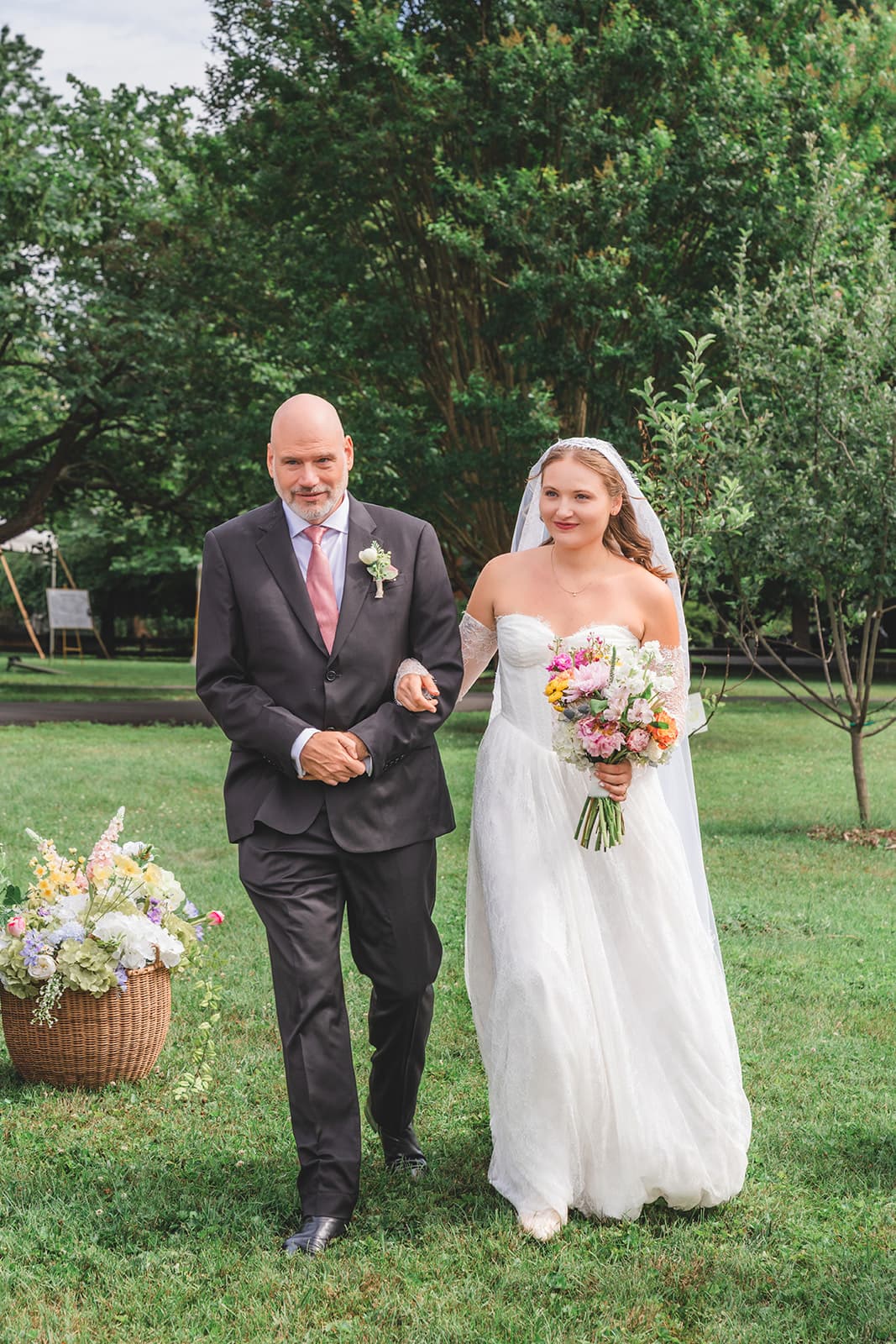 Bride walking down the aisle at an outdoor wedding ceremony