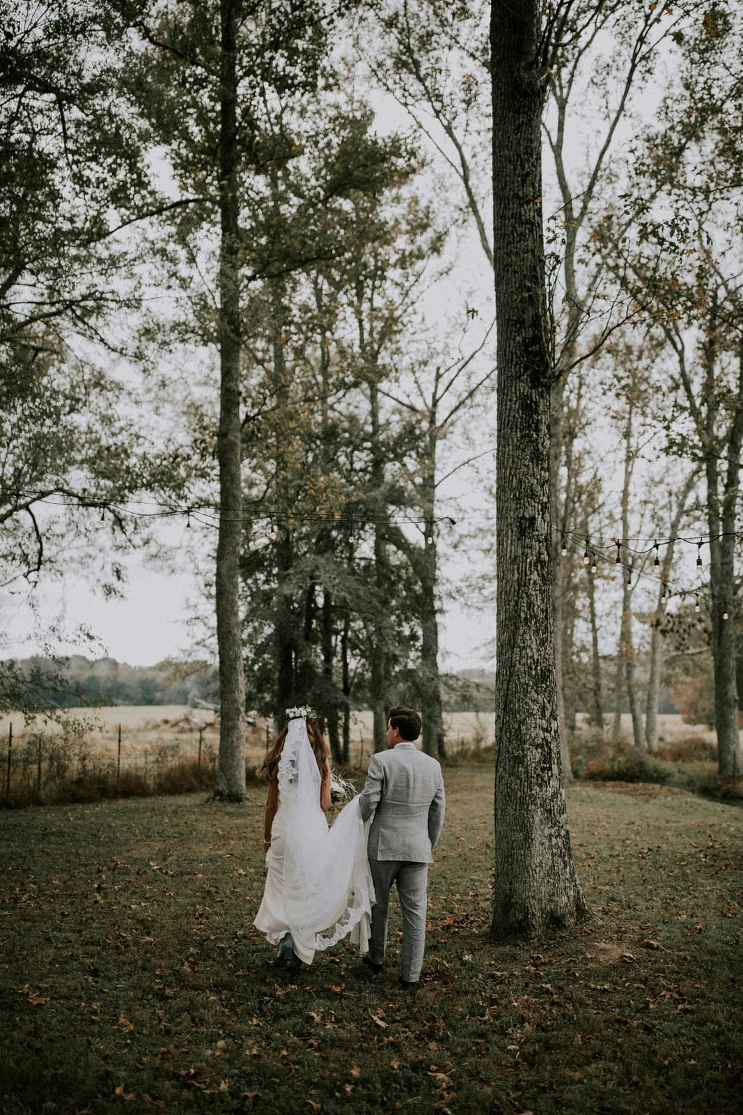 A couple with their photographer during their wedding day